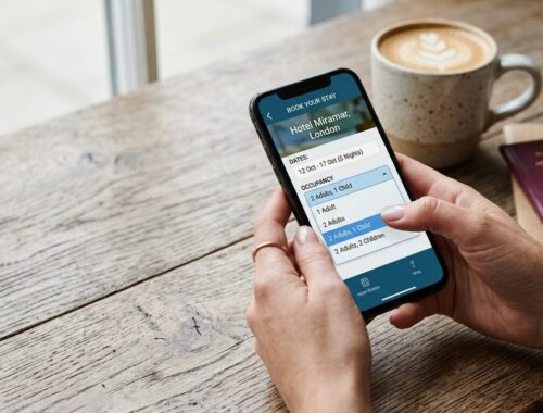 Person checking hotel room occupancy limits on a smartphone